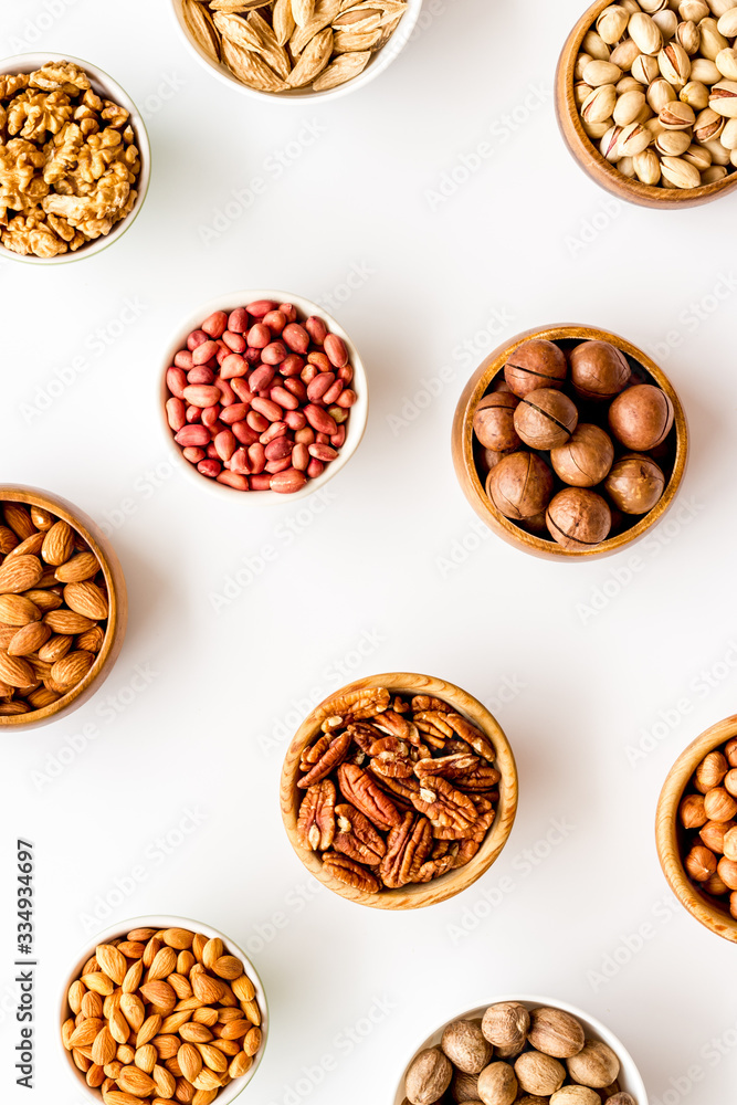 Set of macadamia, hazelnut, walnut, almond, pistachio, pecans nuts on white background top-down pattern Set of macadamia, hazelnut, walnut, almond, pistachio, pecans nuts on white background top-down pattern