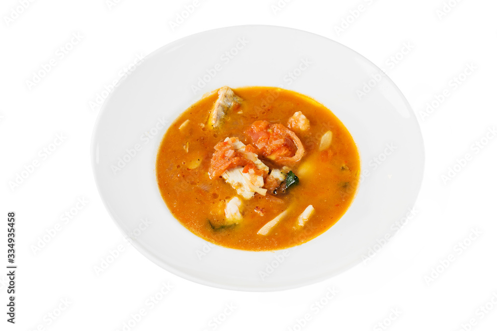 Fish soup in a bowl on white isolated background. Top view, close-up