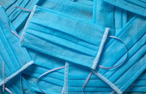 Many folded blue protective masks