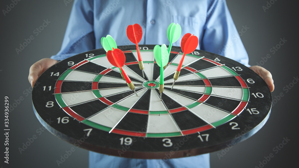 Fototapeta premium Businessman holding dart board with arrows. Target, Business, Success