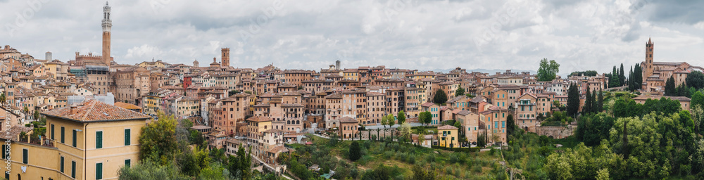 Panorama of Siena, cityscape, a beautiful medieval town in Tuscany, with view of the Dome Bell Tower of Siena Cathedral, landmark Mangia Tower and Basilica of San Domenico, Italy