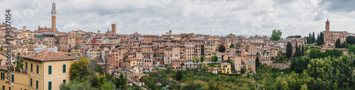 Panorama of Siena, cityscape, a beautiful medieval town in Tuscany, with view of the Dome Bell Tower of Siena Cathedral, landmark Mangia Tower and Basilica of San Domenico, Italy
