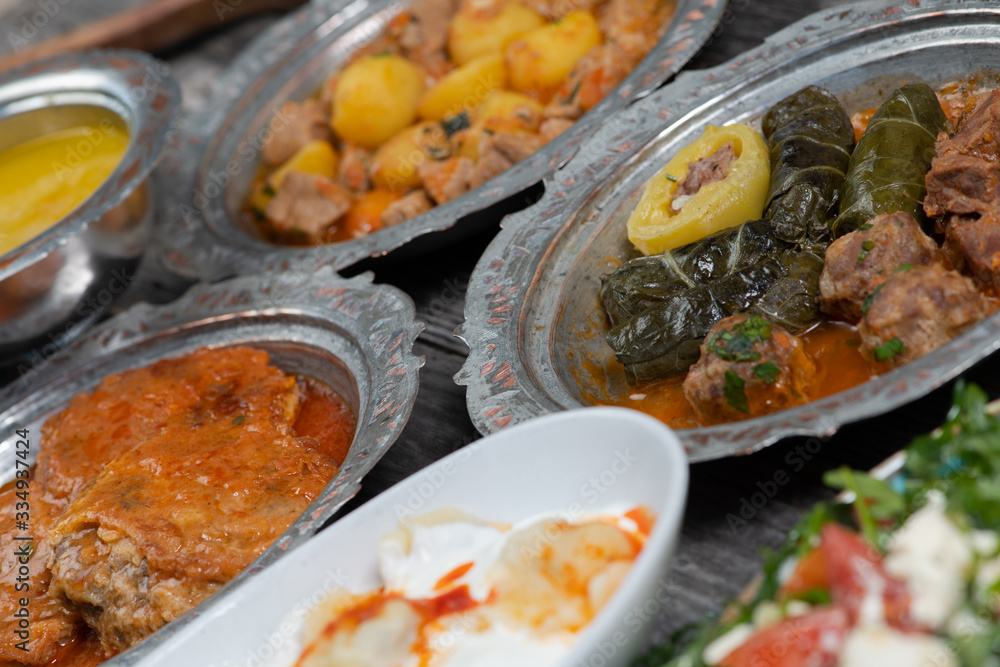 Eid Mubarak Traditional Ramadan Iftar dinner. Assorted tasty food in authentic rustic dishes on wooden table background. Eid Mubarak Traditional Ramadan Iftar dinner. Assorted tasty food in authentic rustic dishes on wooden table background.