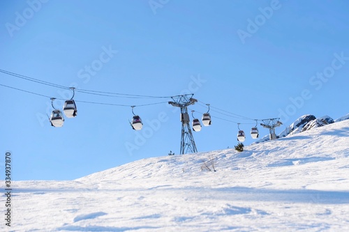 Winter scenery with ski lifts on the slope 
