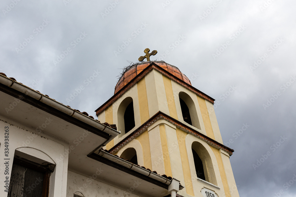 Fototapeta premium Cross on church tower and cloudy sky