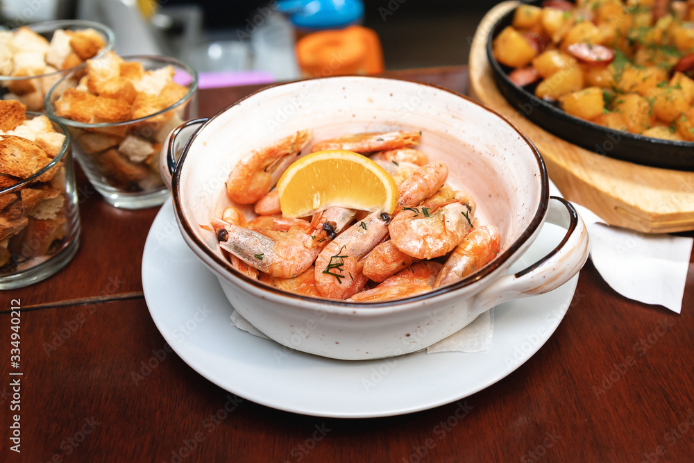 Grilled shrimp with lemon and spices on a white plate