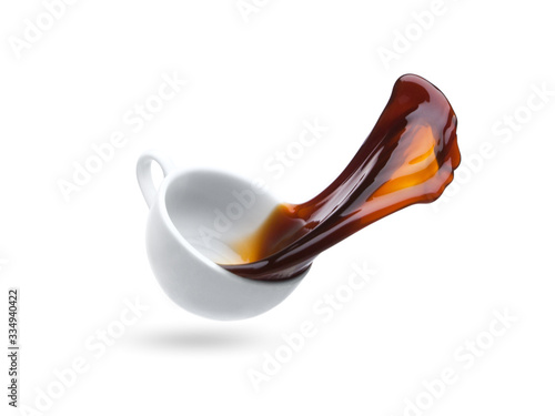 coffee cup falls to the floor, the coffee is poured, splashed on a white background