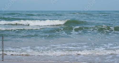 Waves break on tropical sand beach