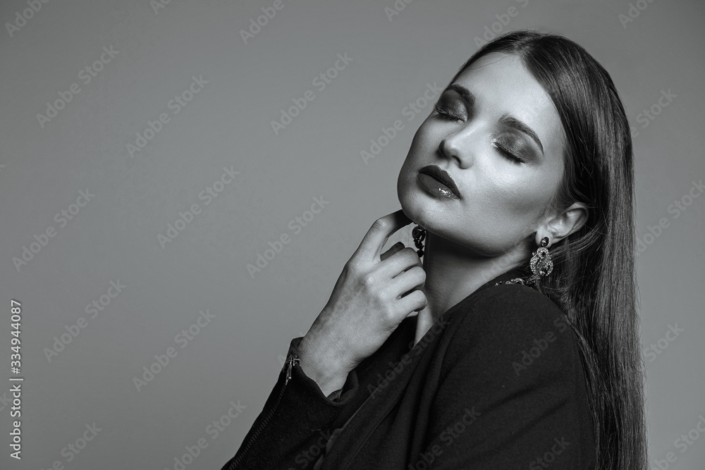 Sensual lady with shiny hair and red lips wears stylish clothing