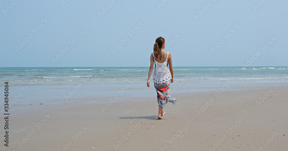 Asian woman walk on the beach