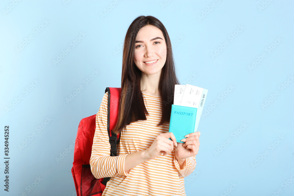 Beautiful young smiling girl holds tickets for travel. Rest, travel, tour.