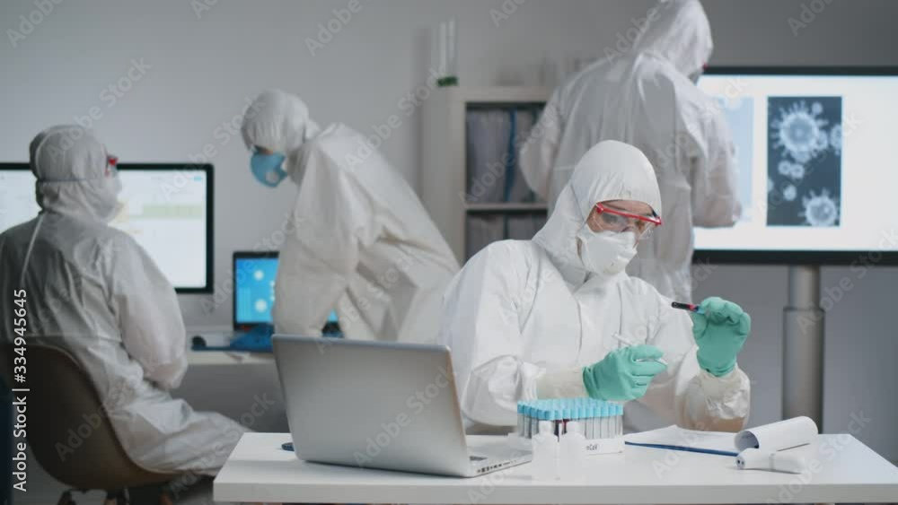 Doctors in laboratory working on vaccine to stop epidemic Doctors in laboratory working on vaccine to stop epidemic