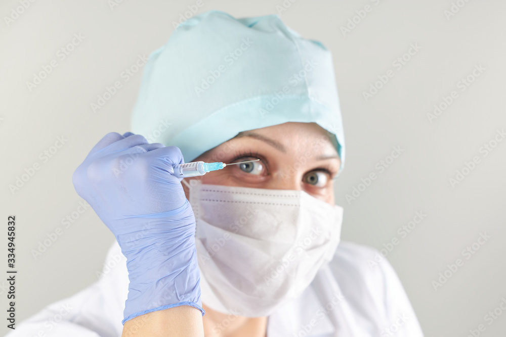Nurse threatens a patient with a syringe with medicine in her hand Nurse threatens a patient with a syringe with medicine in her hand