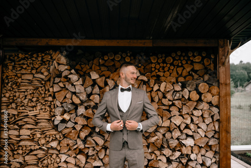 Portrait photo of handsome man wearing in grey suit, tie bow.