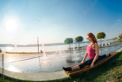 Beautiful woman doing split on a warm summer day. sport active lifestyle concept © RomanR