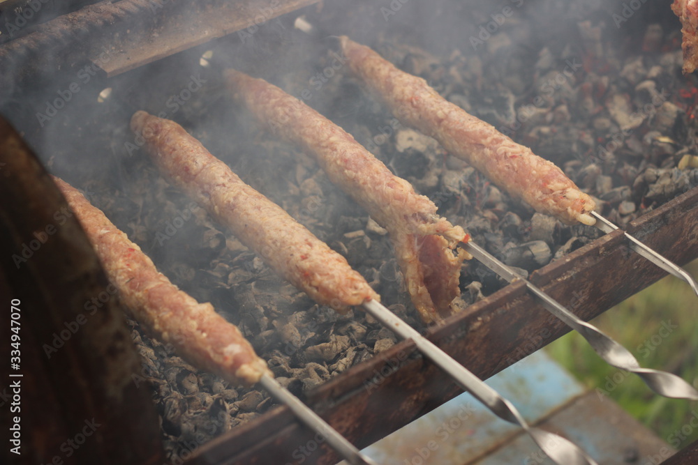 Stuffed meat on skewers. Cooking lula kebab in the fresh air close-up. Stuffed meat on skewers. Cooking lula kebab in the fresh air close-up.