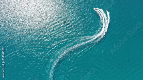 Drone footage of a speedboat pulling people on a tube. photo