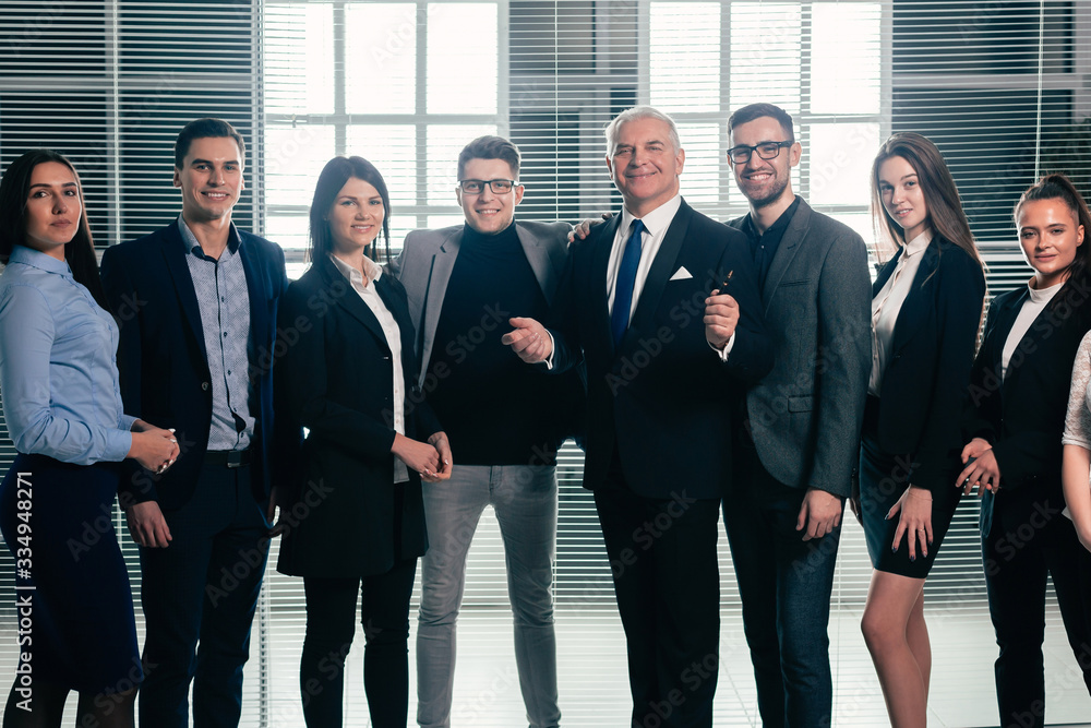 Fototapeta premium group of happy business people standing in the office lobby