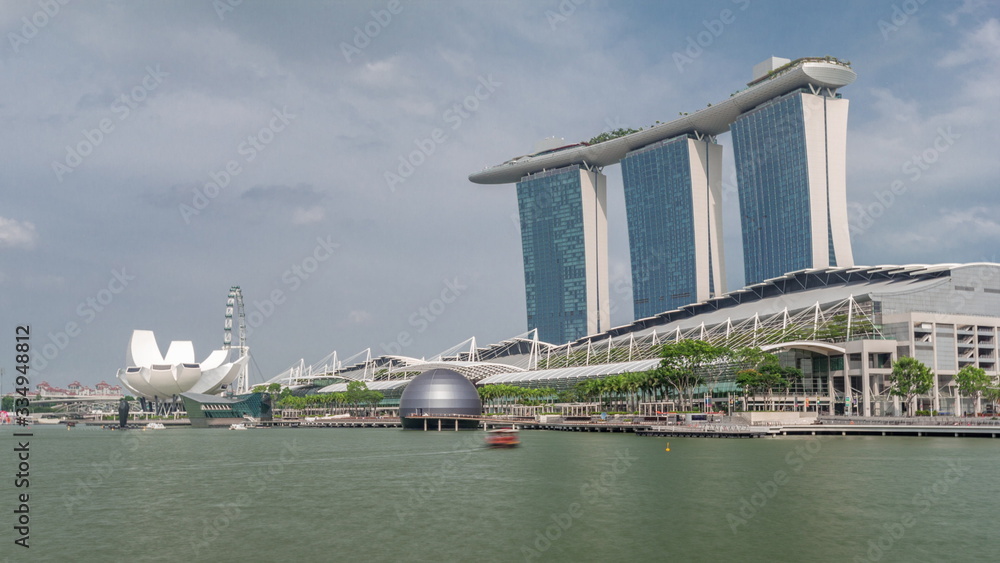 Fifty-five storeys high Marina Bay Sands Hotel dominates the skyline at Marina Bay in Singapore timelapse hyperlapse.