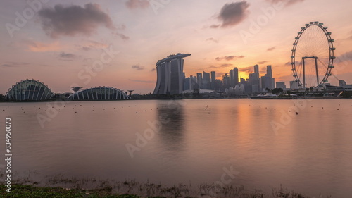 Sunset over the downtown skyline of Singapore as viewed from across the water from The Garden East timelapse. Singapore. © neiezhmakov