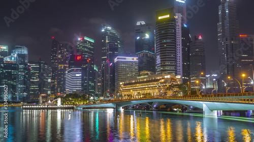 Esplanade bridge and downtown core skyscrapers in the background Singapore night timelapse hyperlapse © neiezhmakov