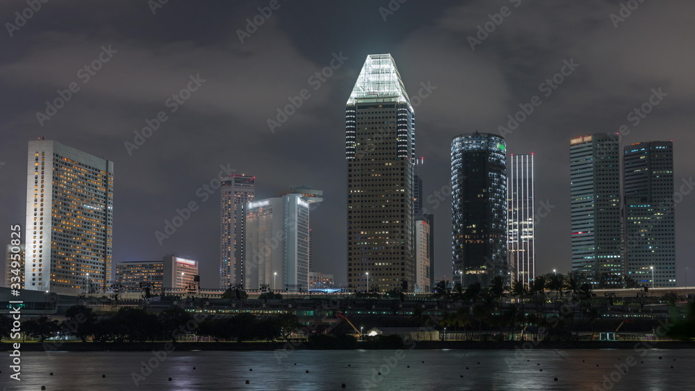 Fototapeta premium Downtown skyline of Singapore as viewed from across the water from The Garden East night timelapse. Singapore.