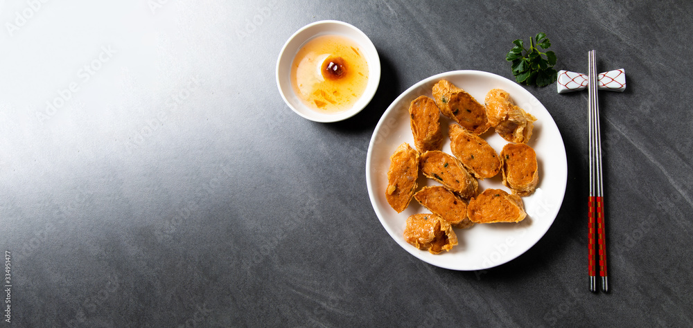 Hae Keung is fried shrimp rolled or shrimp ball. Chinese Traditional cuisine concept. Dumplings Dim Sum in bamboo steamer with text copy space. Asian food background Hae Keung is fried shrimp rolled or shrimp ball. Chinese Traditional cuisine concept. Dumplings Dim Sum in bamboo steamer with text copy space. Asian food background