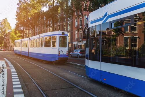 City tram driving throught Amsterdam city at Netherlands