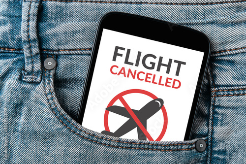 Flight cancelled concept on smartphone screen in jeans pocket. 