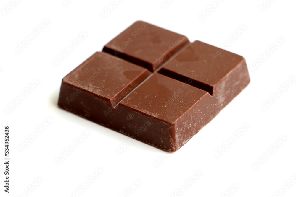 A pile of milk chocolate slab blocks broken up and stacked A pile of milk chocolate slab blocks broken up and stacked
