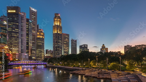 Singapore skyscrapers skyline with white Anderson Bridge near esplanade park day to night timelapse.