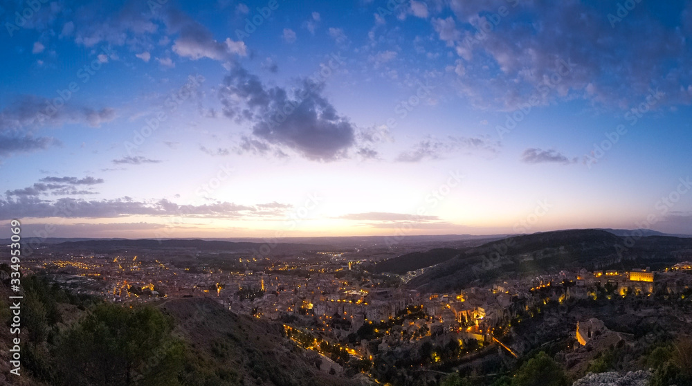 Wide panoramic view of the city of Cuenca from the observation deck Sacred Heart of Jesus - Cerro del Socorro. Sunset over the city.