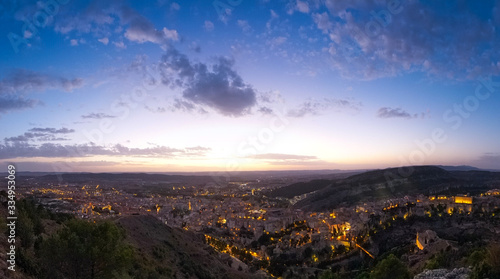 Wide panoramic view of the city of Cuenca from the observation deck Sacred Heart of Jesus - Cerro del Socorro. Sunset over the city.