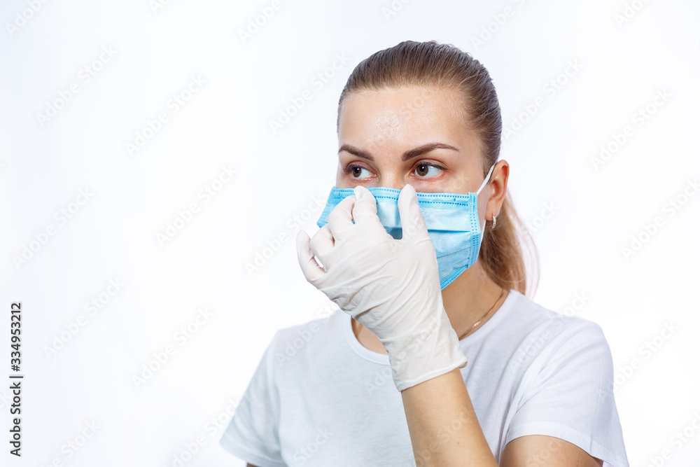 woman health worker demonstrates how to wear a protective medical surgical mask against the virus. Isolated on white background