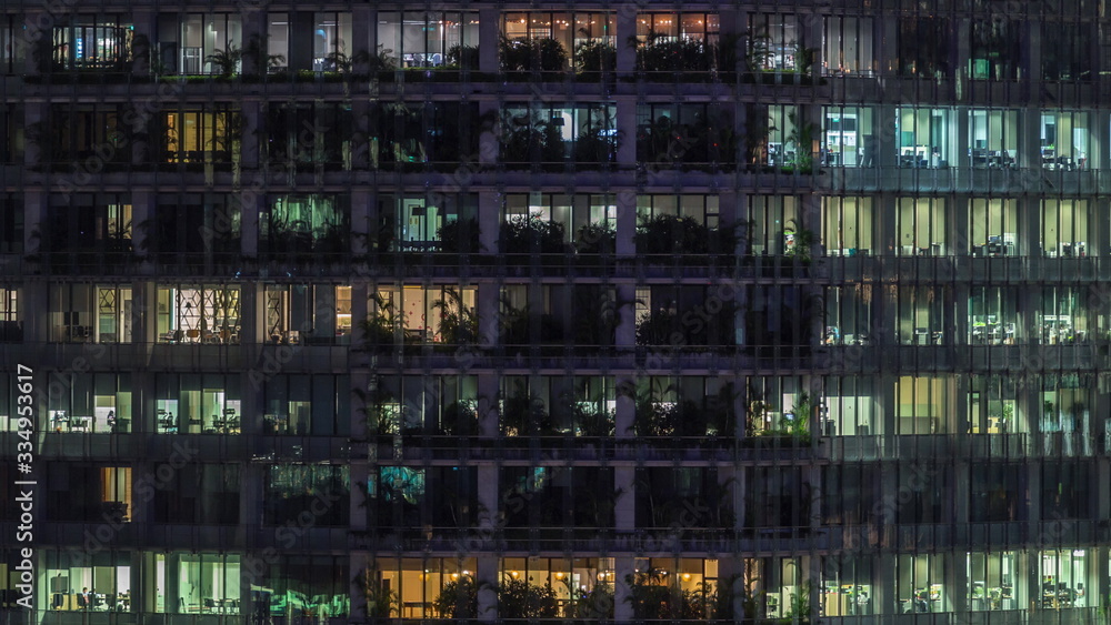 Modern office building with big windows at night timelapse, in windows light shines Modern office building with big windows at night timelapse, in windows light shines