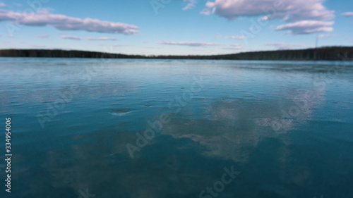 the turquoise sky and the ice of a frozen pond lake © Evgeniy Klyshnikov
