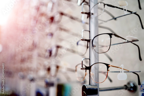 Many glasses on a stand. Showcase with glasses in modern ophthalmic store. Closeup. © Vadim