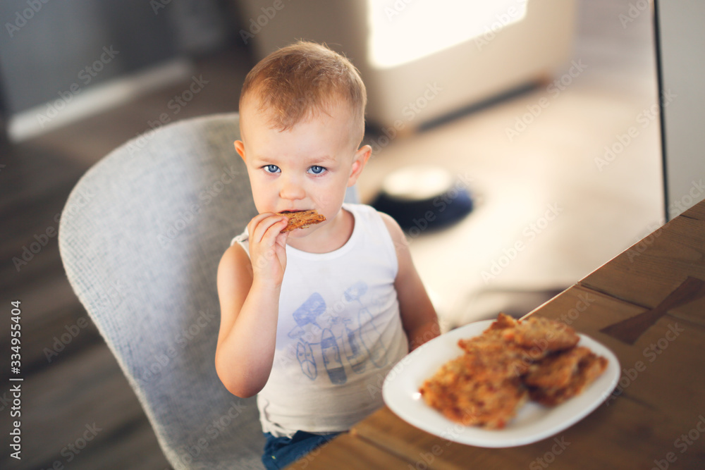 Caucasian boy eating homemade cookies Caucasian boy eating homemade cookies