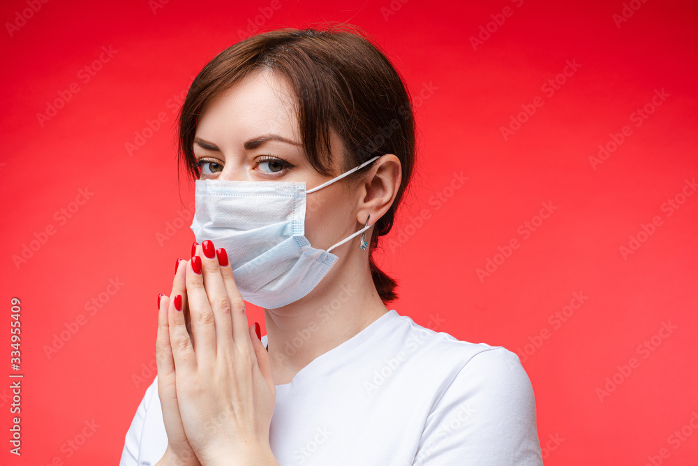 Brunette Caucasian woman in aseptic mask with hands together. Model in mask praying for the world. Brunette woman in protective mask keeping calm with her hands pressed. Brunette Caucasian woman in aseptic mask with hands together. Model in mask praying for the world. Brunette woman in protective mask keeping calm with her hands pressed.
