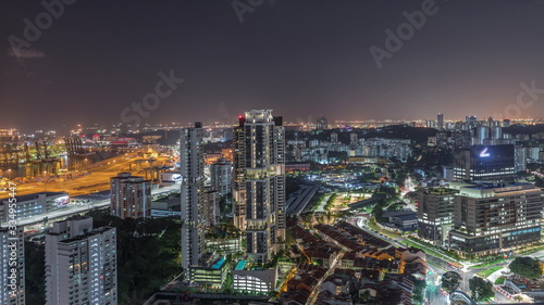 City skyline with commercial port of Singapore aerial night timelapse. © neiezhmakov