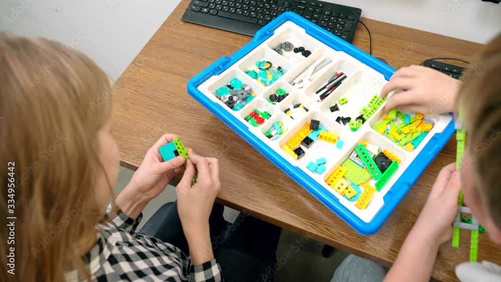 Children using building kit in classroom. Children using building kit in classroom.