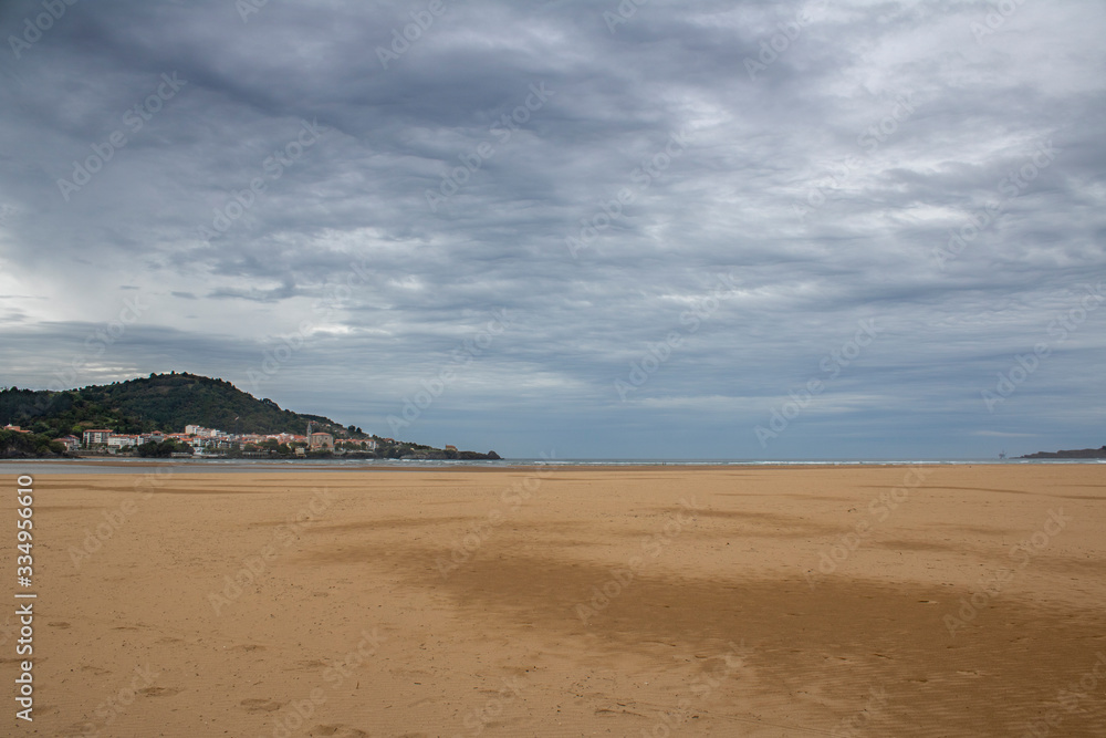 Castro Urdiales beach on a day with gray clouds. Castro Urdiales beach on a day with gray clouds.