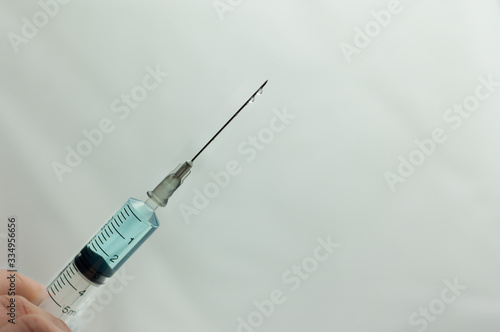 blue liquid in a syringe on a white background