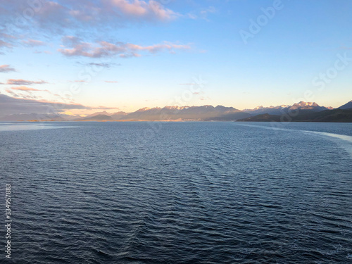 Sunrise over Ushuaia with Full Moon in Patagonia during cruising on luxury cruise ship or cruiseship liner on Beagle Channel between Argentina and Chile with breathtaking natural landscape photo