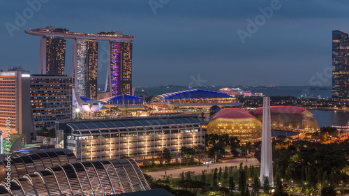 Evening panorama with Marina Bay area and skyscrapers city skyline aerial day to night timelapse. photo