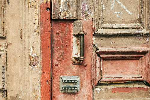 Close up of wooden weathered door with rusty and lock