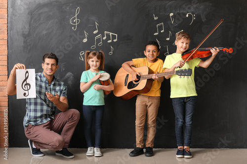 Music teacher with little c...