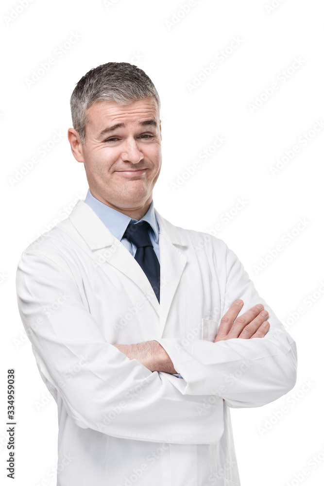 Sceptical doctor smiling at camera with cynicism Sceptical doctor smiling at camera with cynicism