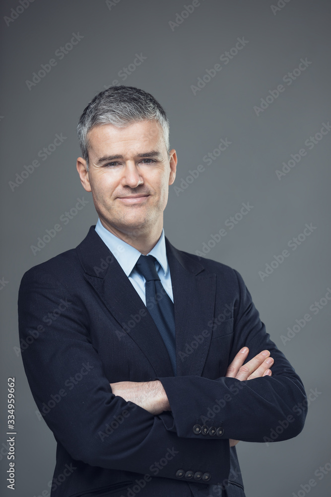 Successful relaxed businessman with folded arms Successful relaxed businessman with folded arms