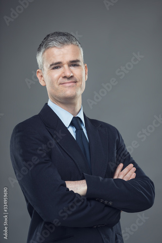 Successful relaxed businessman with folded arms